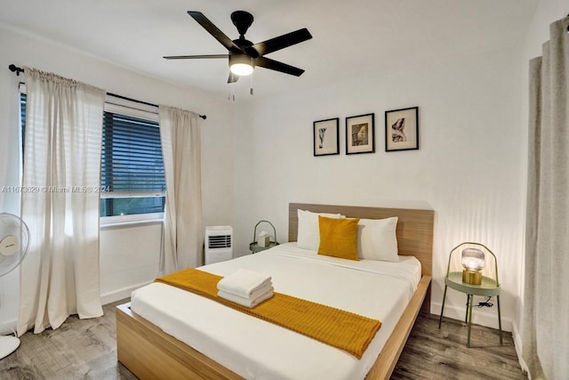 bedroom with wood-type flooring and ceiling fan