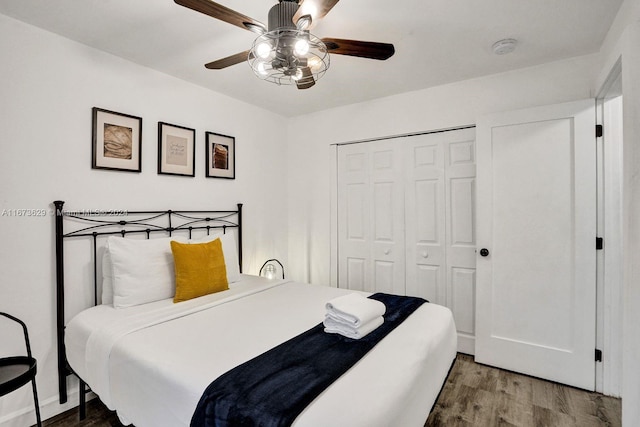 bedroom featuring a closet, hardwood / wood-style flooring, and ceiling fan