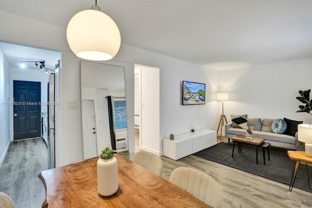 dining space with hardwood / wood-style floors