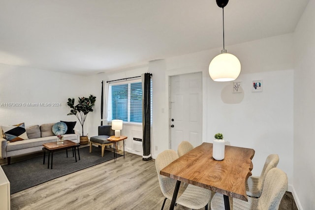 dining space with wood-type flooring