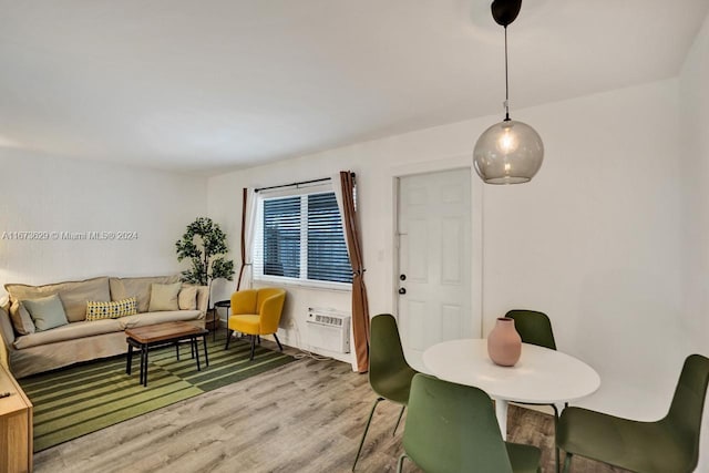 dining space featuring hardwood / wood-style flooring and a wall mounted AC