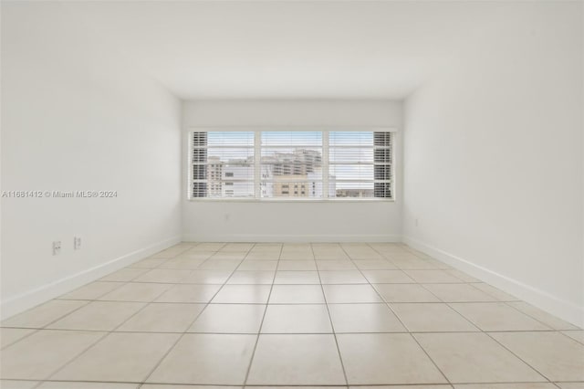 spare room featuring light tile patterned flooring