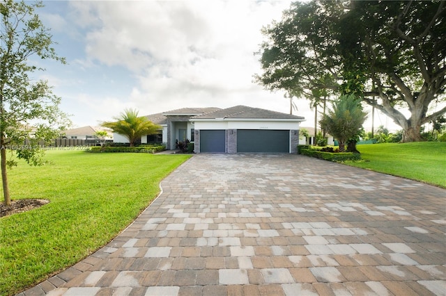 view of front of property featuring a front lawn and a garage