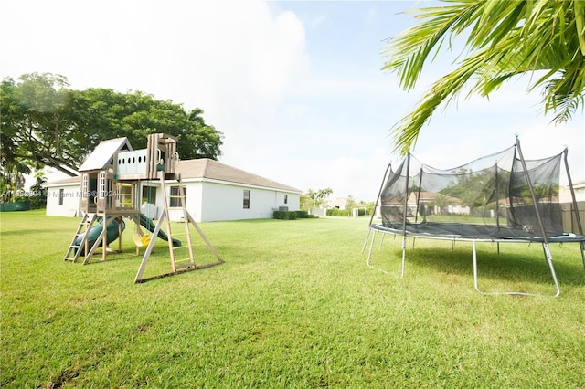 view of yard featuring a playground and a trampoline