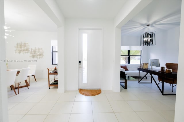 foyer entrance featuring a chandelier and light tile patterned floors