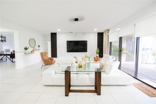 living room with an inviting chandelier and light tile patterned flooring