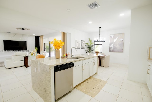 kitchen featuring a kitchen island with sink, sink, stainless steel dishwasher, white cabinets, and light stone counters