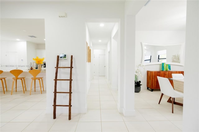 hall with light tile patterned floors