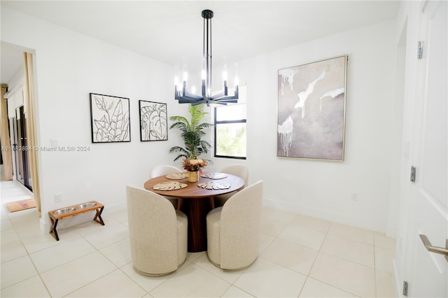 dining area with light tile patterned floors and an inviting chandelier