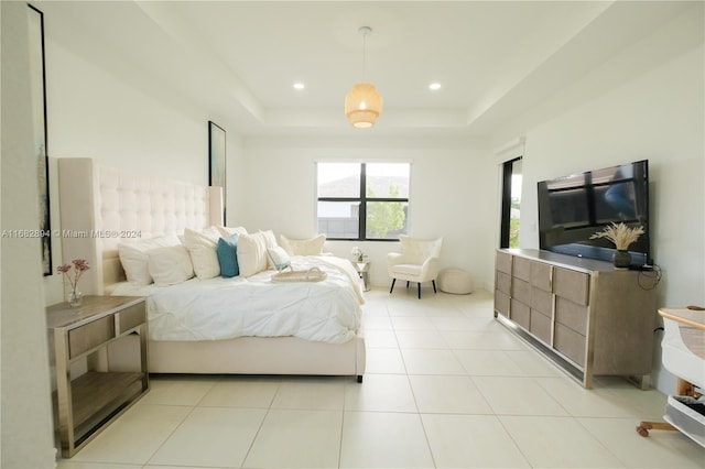 tiled bedroom with a raised ceiling