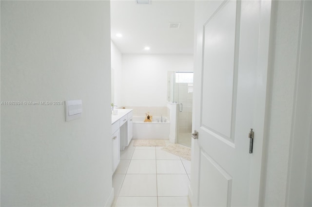 bathroom with vanity, plus walk in shower, and tile patterned flooring