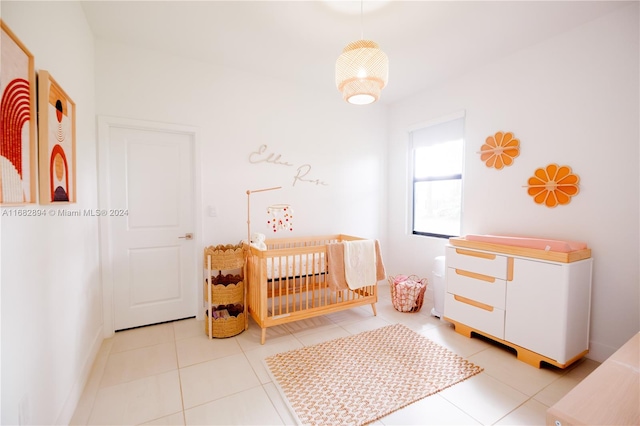 tiled bedroom featuring a crib