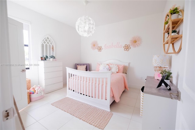 bedroom with an inviting chandelier and light tile patterned floors