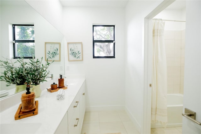 bathroom with a wealth of natural light, vanity, shower / tub combo, and tile patterned flooring