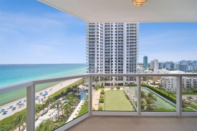 balcony featuring a water view and a beach view