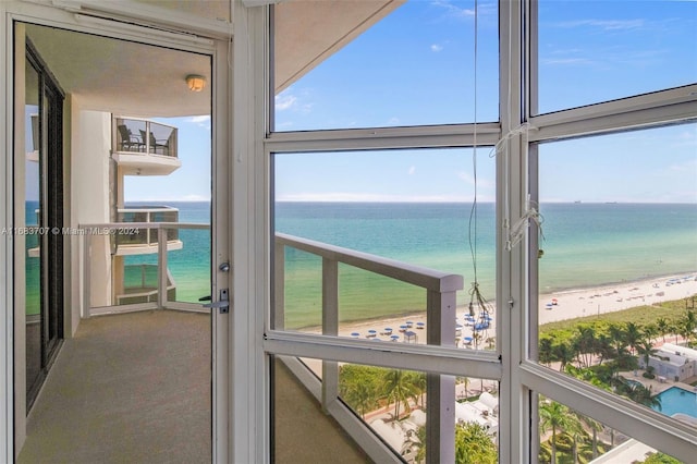 interior space with a water view and a beach view