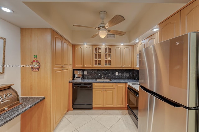 kitchen featuring backsplash, sink, black appliances, light tile patterned floors, and ceiling fan