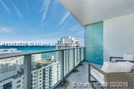 balcony featuring a water view and a view of the beach