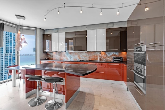 kitchen with a spacious island, a wealth of natural light, and a breakfast bar area