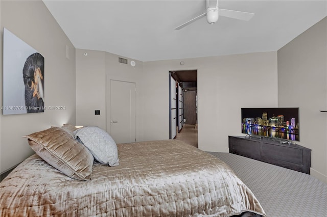 bedroom featuring ceiling fan and carpet