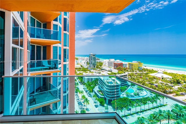 balcony featuring a water view and a view of the beach