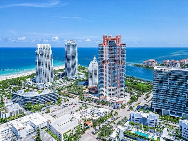 birds eye view of property with a water view and a view of the beach