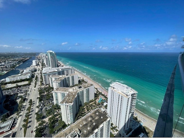 drone / aerial view with a water view and a beach view