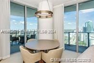 dining area featuring expansive windows, a notable chandelier, and plenty of natural light