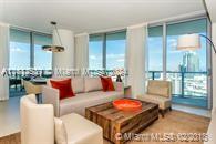 living room featuring plenty of natural light and floor to ceiling windows