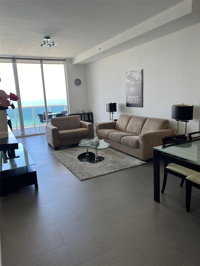 living room with a water view and floor to ceiling windows