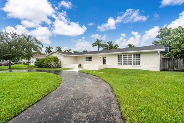 ranch-style home with a front yard