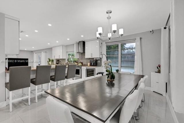 dining area featuring a chandelier and beverage cooler