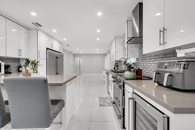 kitchen featuring tasteful backsplash, appliances with stainless steel finishes, sink, and white cabinets