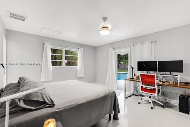 tiled bedroom with access to exterior