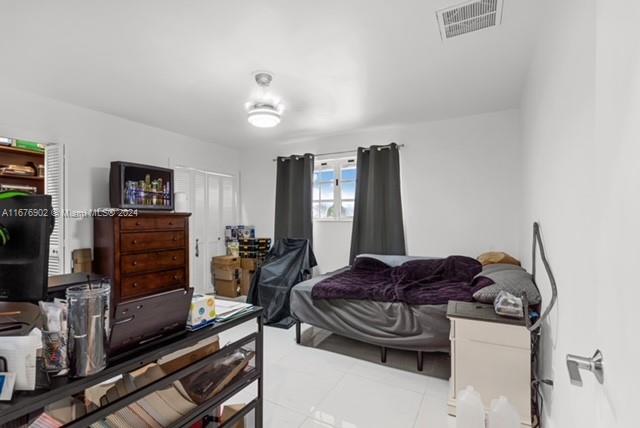 bedroom featuring light tile patterned floors