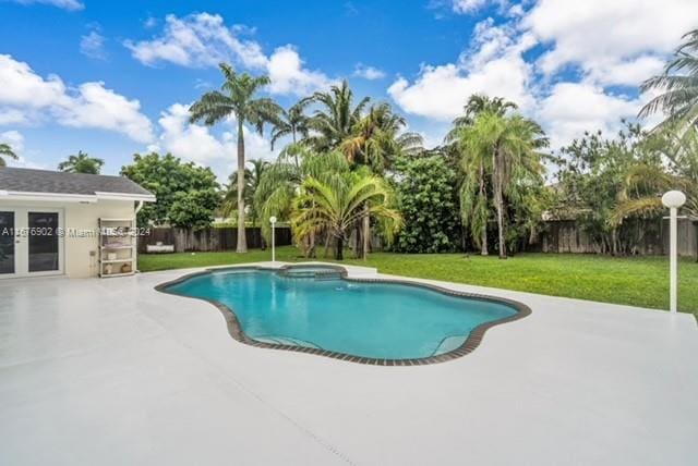 view of pool featuring a patio, an in ground hot tub, and a lawn