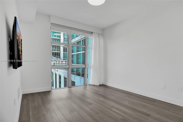 unfurnished room with wood-type flooring