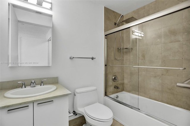 full bathroom with toilet, combined bath / shower with glass door, and vanity