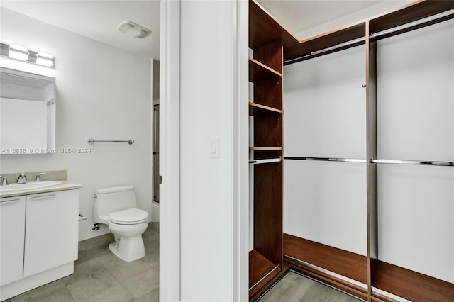 full bathroom with toilet, enclosed tub / shower combo, and vanity