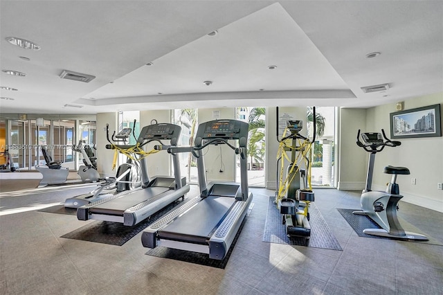 exercise room featuring a tray ceiling