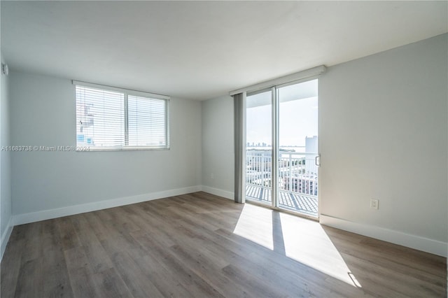 unfurnished room with wood-type flooring