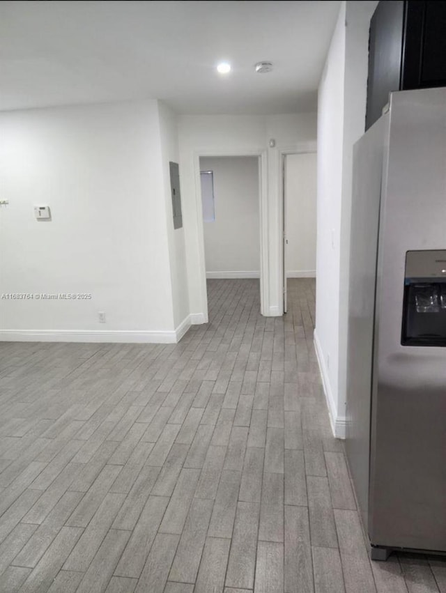 corridor with recessed lighting, baseboards, and wood finished floors
