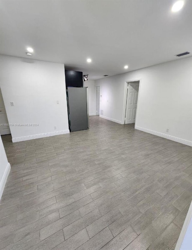 empty room with light hardwood / wood-style flooring