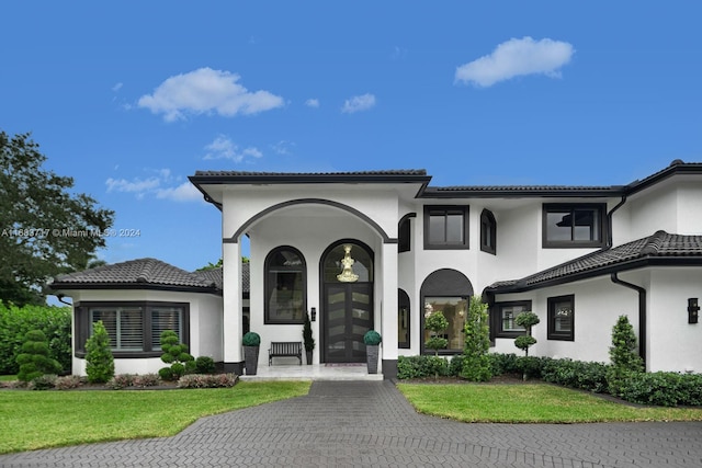 2440 SW 105th Ter, Davie, FL 33324 - mediterranean / spanish-style house featuring stucco siding, a front yard, and a tiled roof