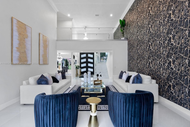 living room with crown molding, light tile patterned floors, and an inviting chandelier