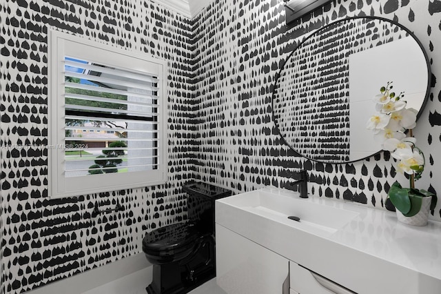 bathroom with vanity, toilet, and tile walls