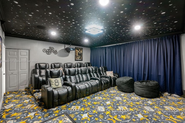 carpeted home theater with crown molding