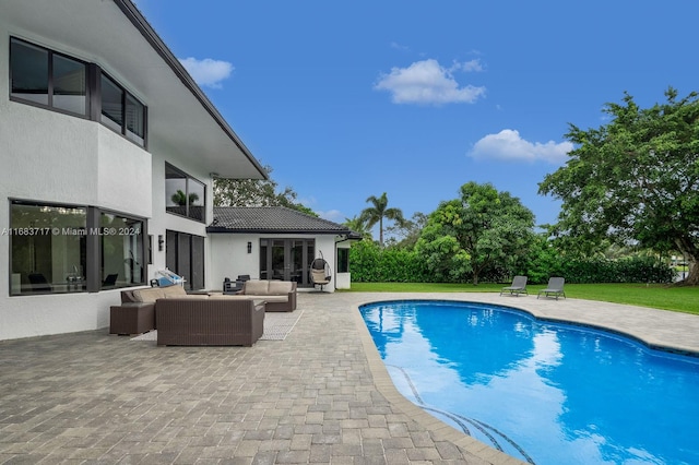 view of swimming pool featuring a patio, a yard, and an outdoor hangout area