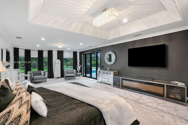 carpeted bedroom with crown molding, multiple windows, and a raised ceiling