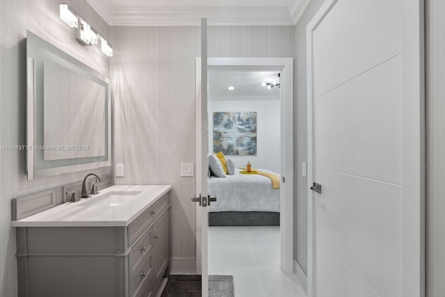 bathroom with vanity, ornamental molding, and tile patterned flooring